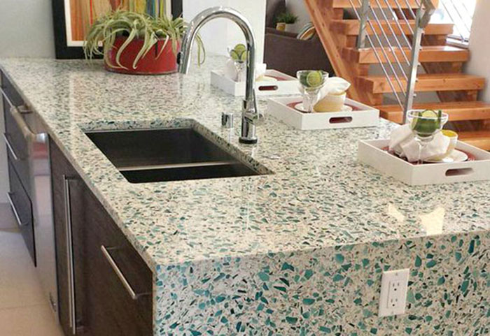 kitchen island with sink and counter tops made of recycled glass