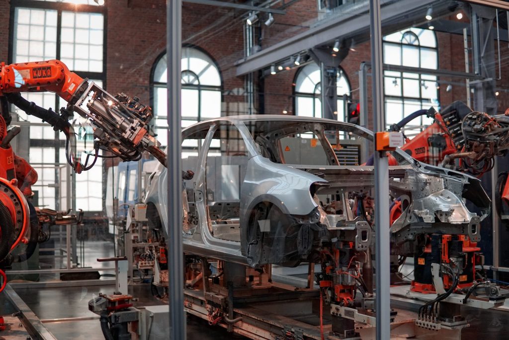 Image of a grey vehicle being assembled in a factory